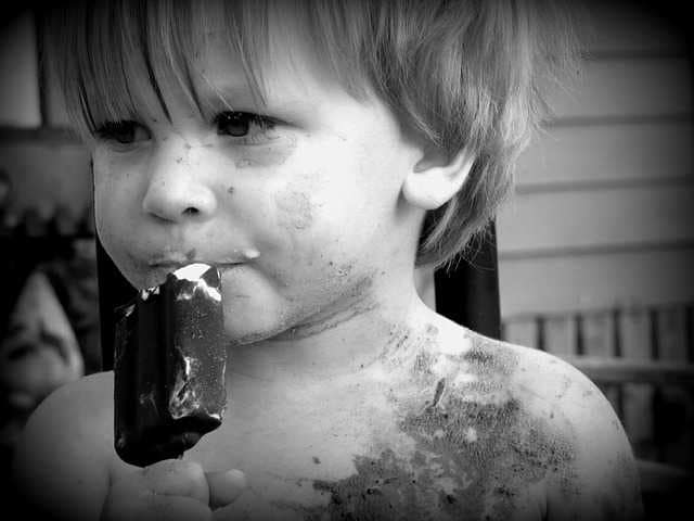 dirty face kid eating